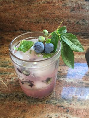 Bennett Blueberry lemonade in glass with blueberry sprig for garnish. 